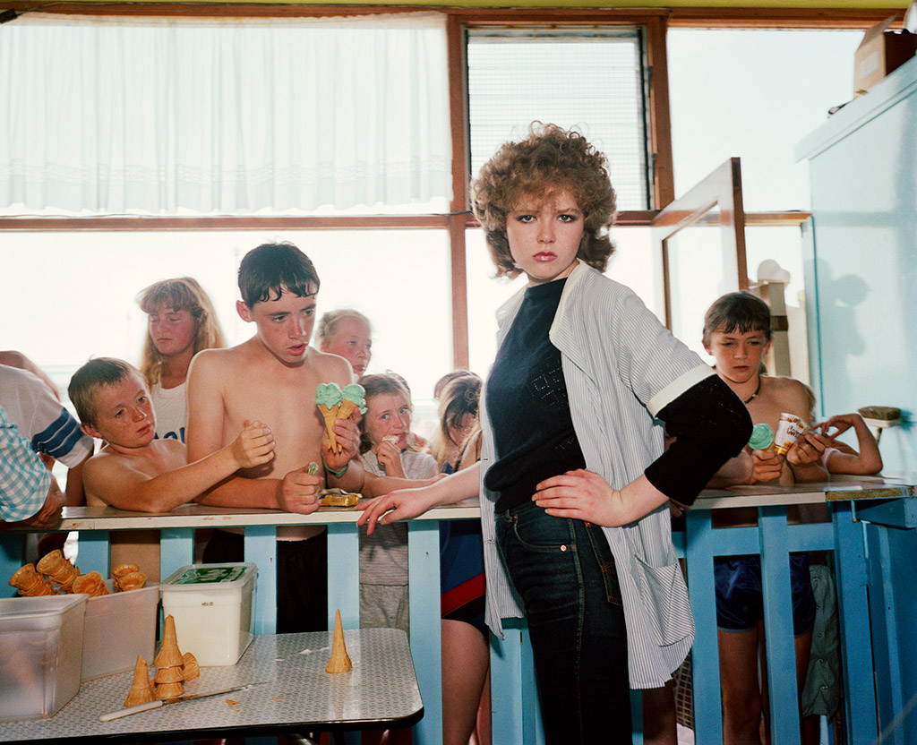 woman with curly hair posing with hand on hip i am martin parr