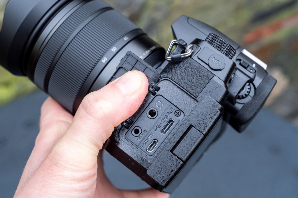 Panasonic Lumix G97 on a metal table, the input sockets