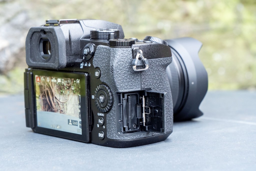 Panasonic Lumix G97 on a metal table, showing single SD card slot