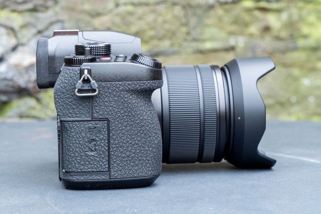 Panasonic Lumix G97 on a metal table, side view