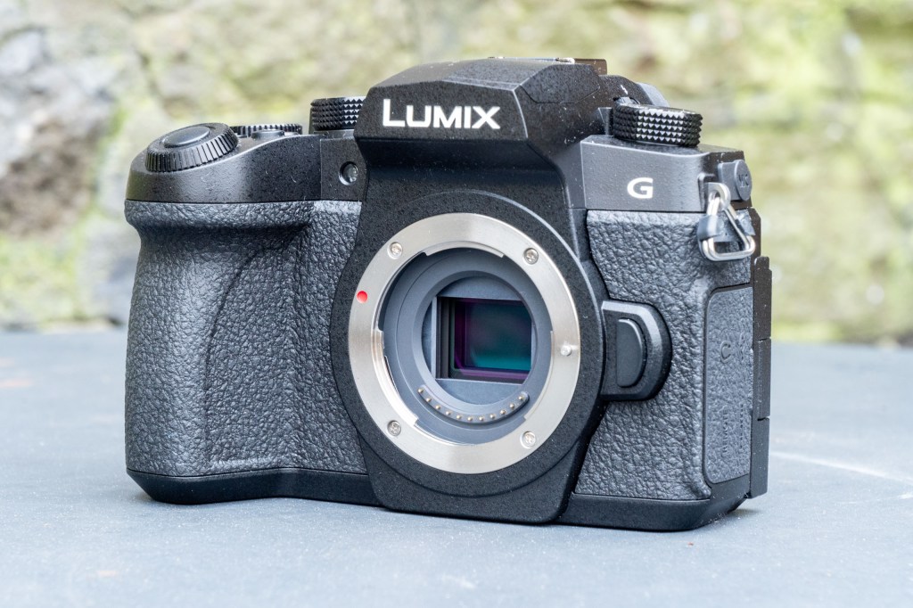 Panasonic Lumix G97 on a metal table, with no lens attached, showing the Four Thirds sensor