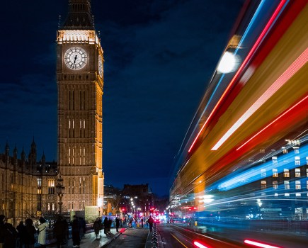 long exposure night photo taken using a phone and tripod of red bus past big ben