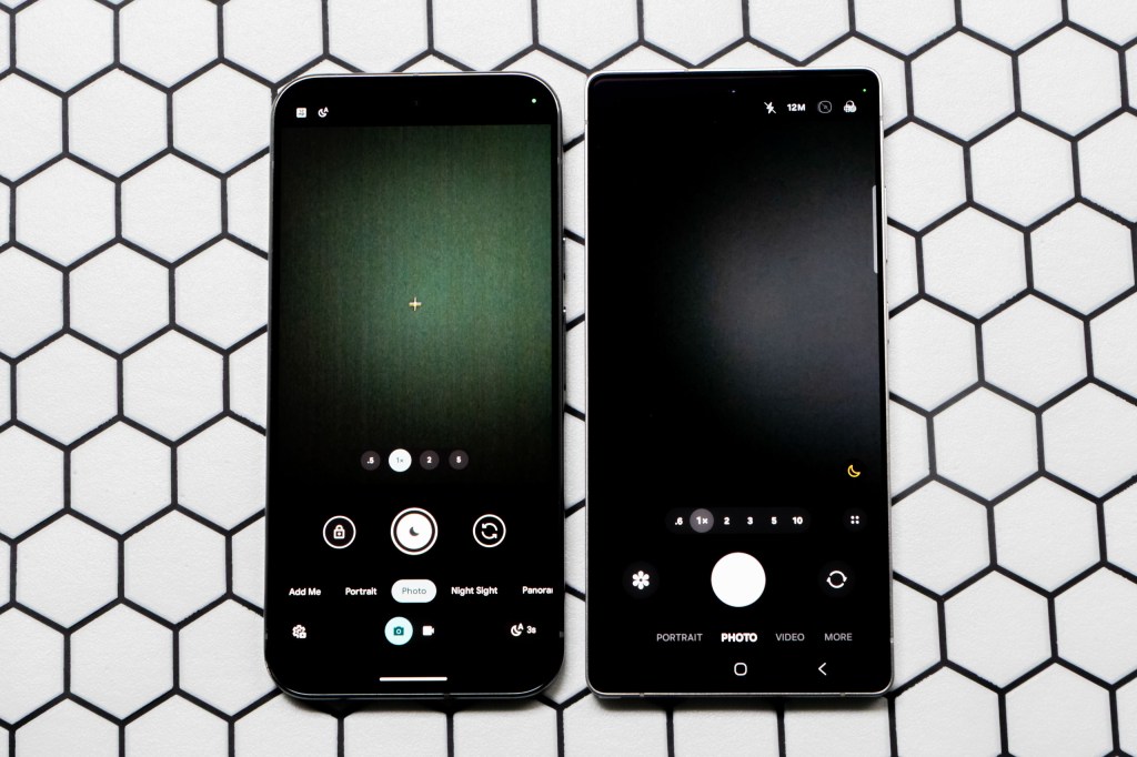 The Google Pixel 9 Pro XL (left) next to the Samsung Galaxy S25 Ultra, with the screens switched on