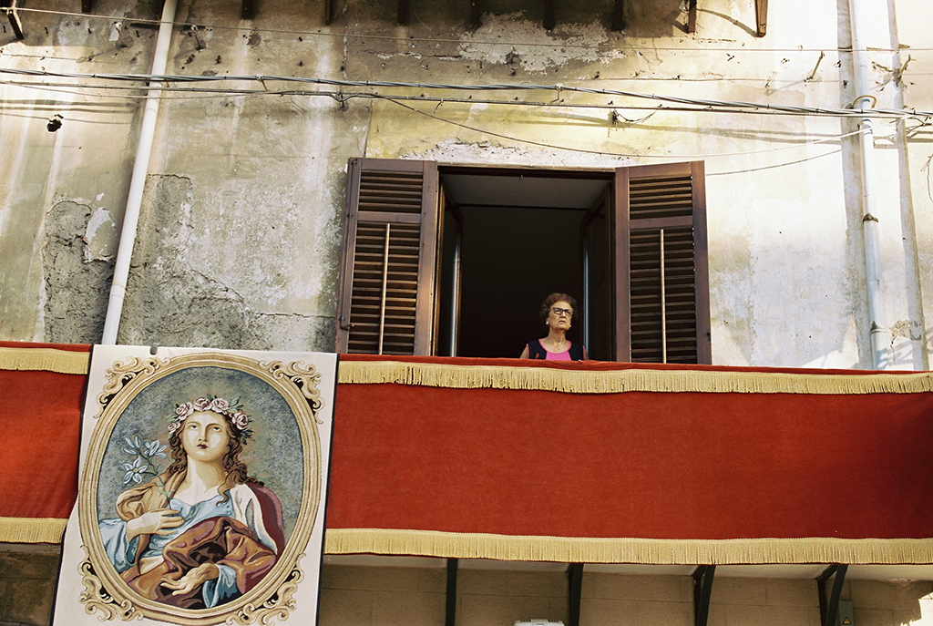 film photo in italy person on red balcony