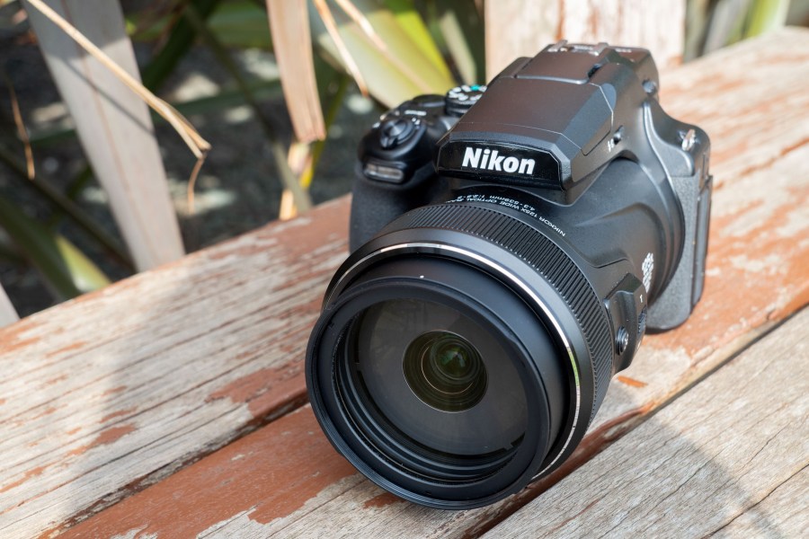 The Nikon P1100 on a wooden surface