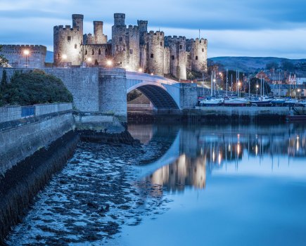Convy castle at dusk reflected in the water