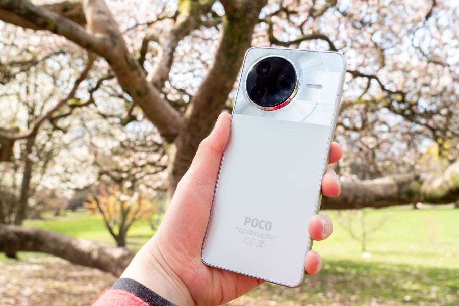 The Poco F7 Pro in hand, silver