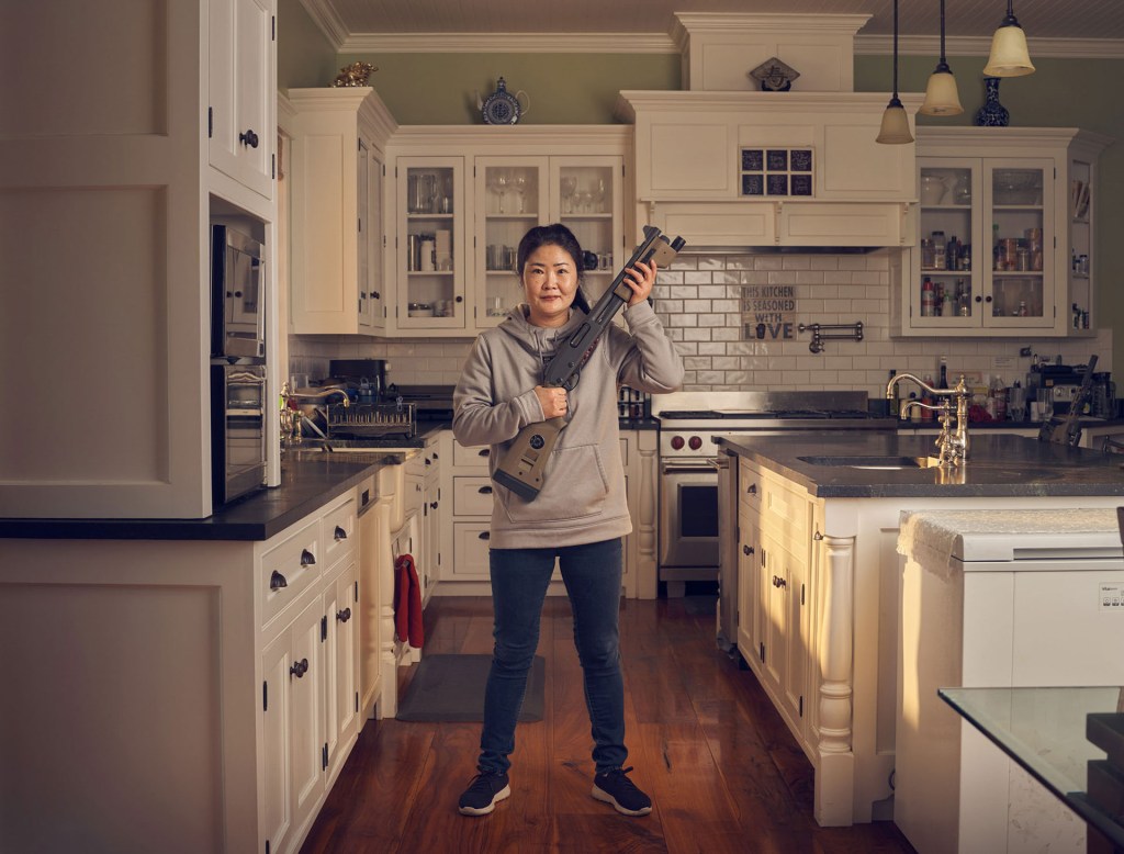 ‘Do you have a favourite gun?’ Franks asked Eunju over tea, casually shifting the direction of the conversation. Her eyes lit up. ‘Yes, I’ll show you’ she replied enthusiastically, as she strolled out of the room momentarily. Re-entering the kitchen she looked at the photographer with a giddy smile. ‘This is my favourite,’ she said with a sense of pride, ‘The Remington 870 Police Magnum Short Barrel Shotgun.’