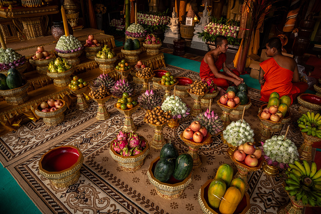 Monks at the temple in Angkor Wat, Cambodia prepare traditional Buddhist offerings
