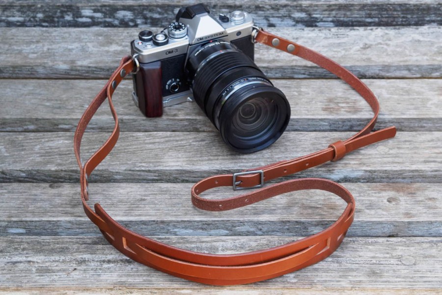 Bowman Summit camera strap on the OM System OM-3 with 12-100mm lens and add-on handgrip