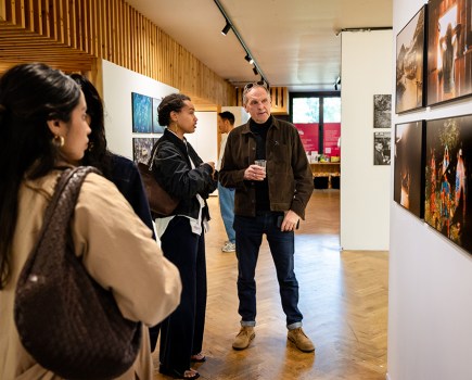 people looking at photos at an exhibition