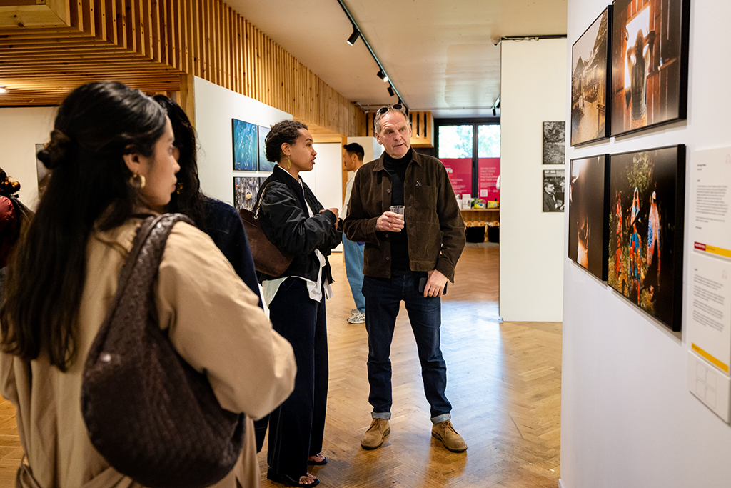 people looking at photos at an exhibition