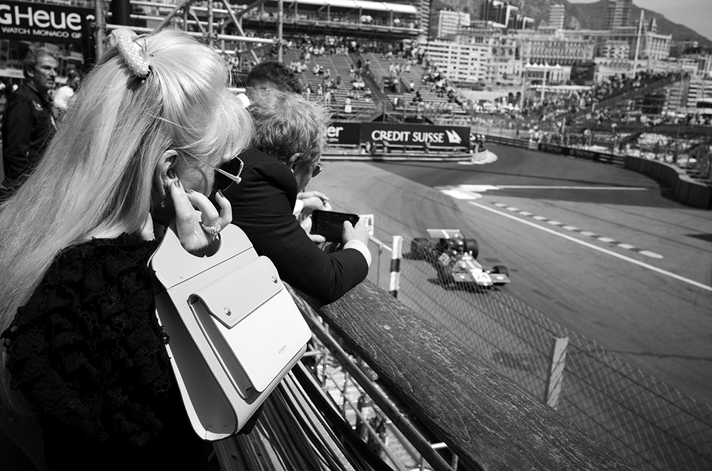 woman holding hand and fingers in her ears at F1 race