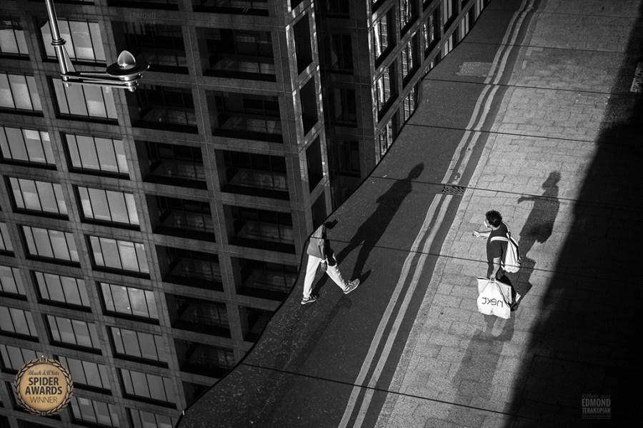 black and white street photography workshop photograph taken in a puddle reflection