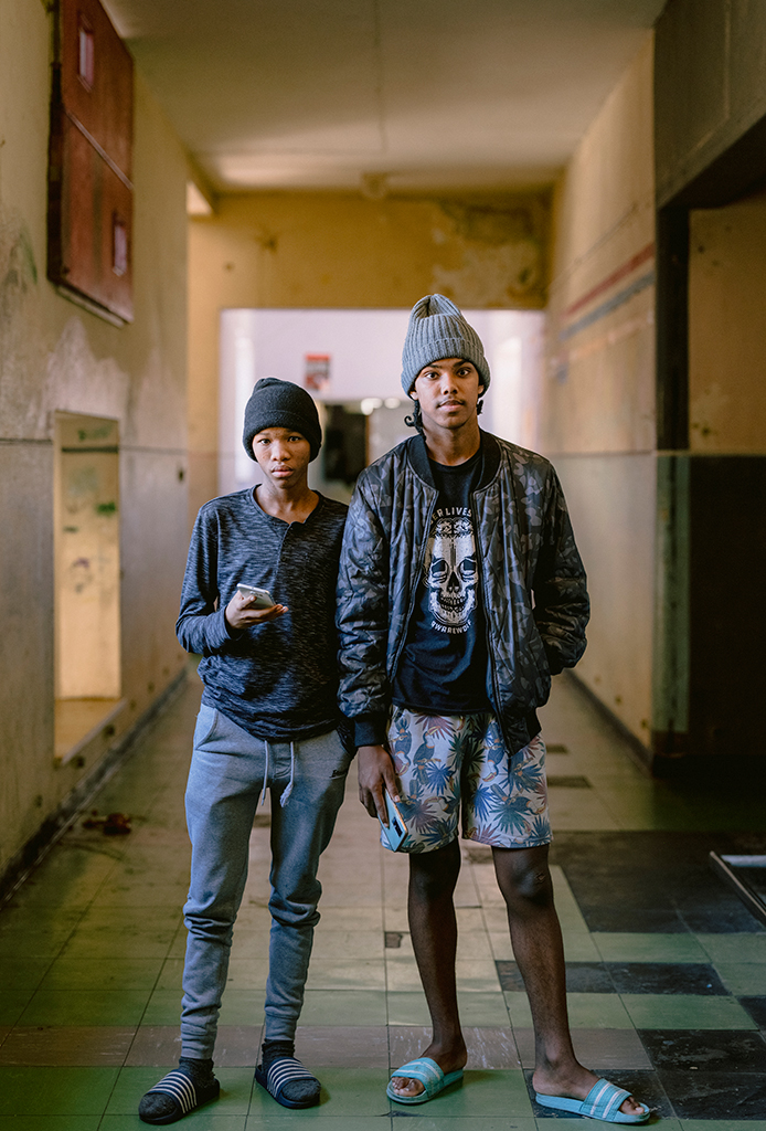 Jadewin Khan (16), left, and Clinton Puti (18), right, pose for a portrait in the hallway of the occupation building.
