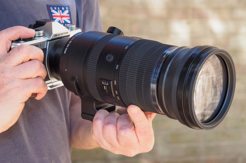 OM System 150-600mm F5-6.3 IS in-hand on OM System OM-3