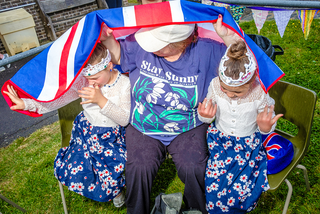 three people sat underneath a union jack