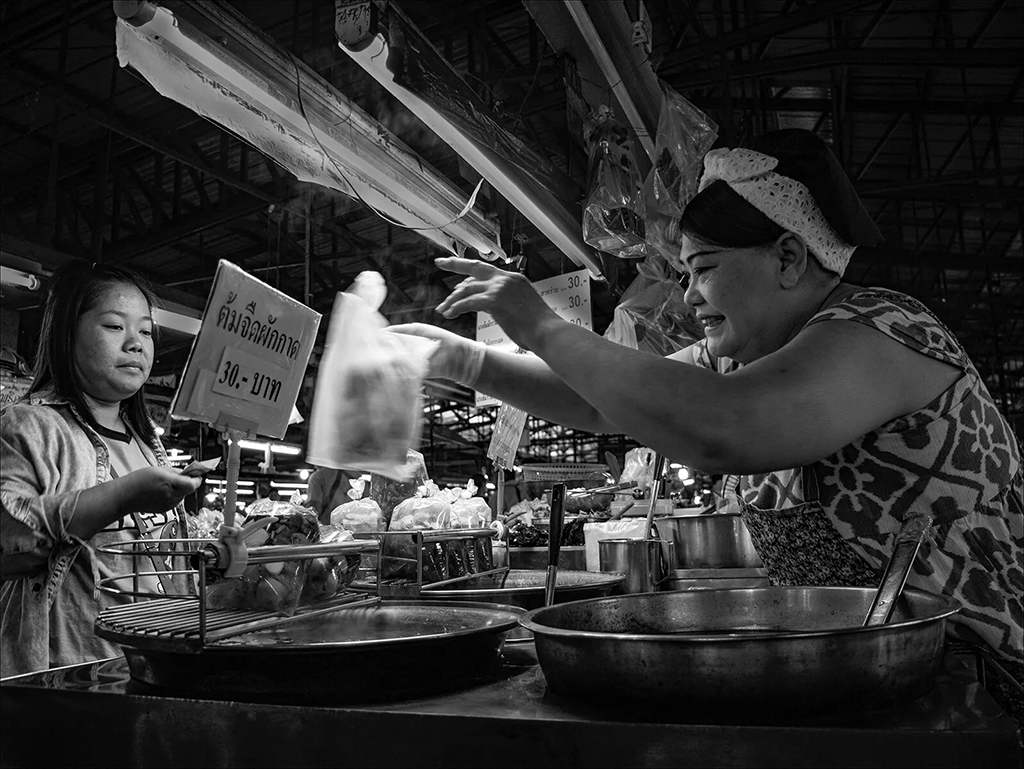 street food market vendor engaging with customer