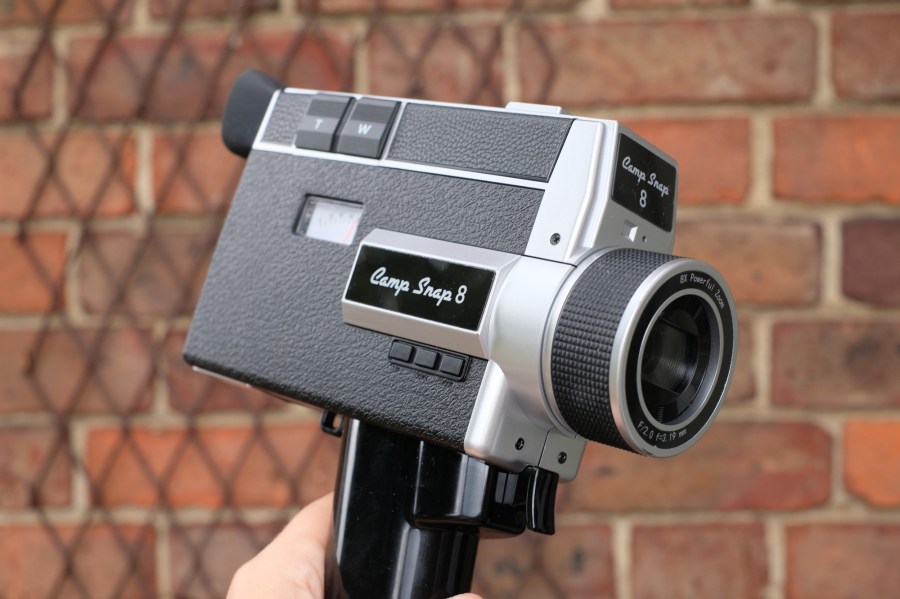 Photograph of the Camp Snap CS8 digital video camera, showing logo, handle and lens.