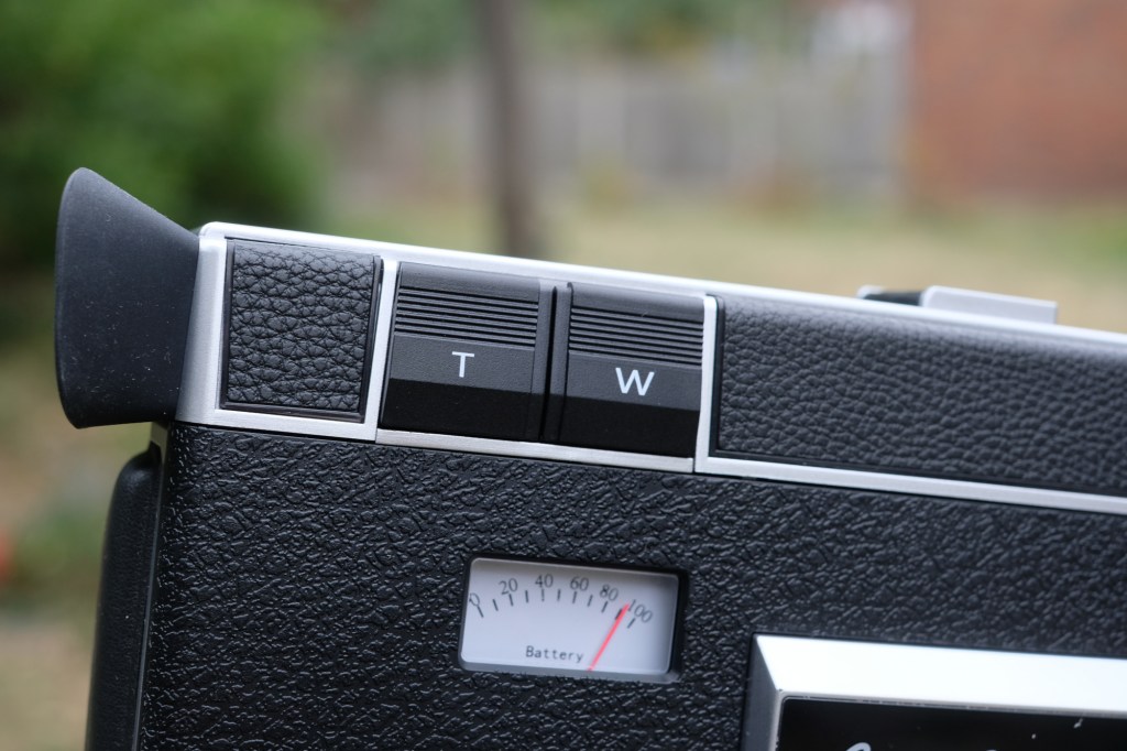 Photograph of the 'Telephoto' and 'Wide' zoom buttons on the Camp Snap CS8 video camera.