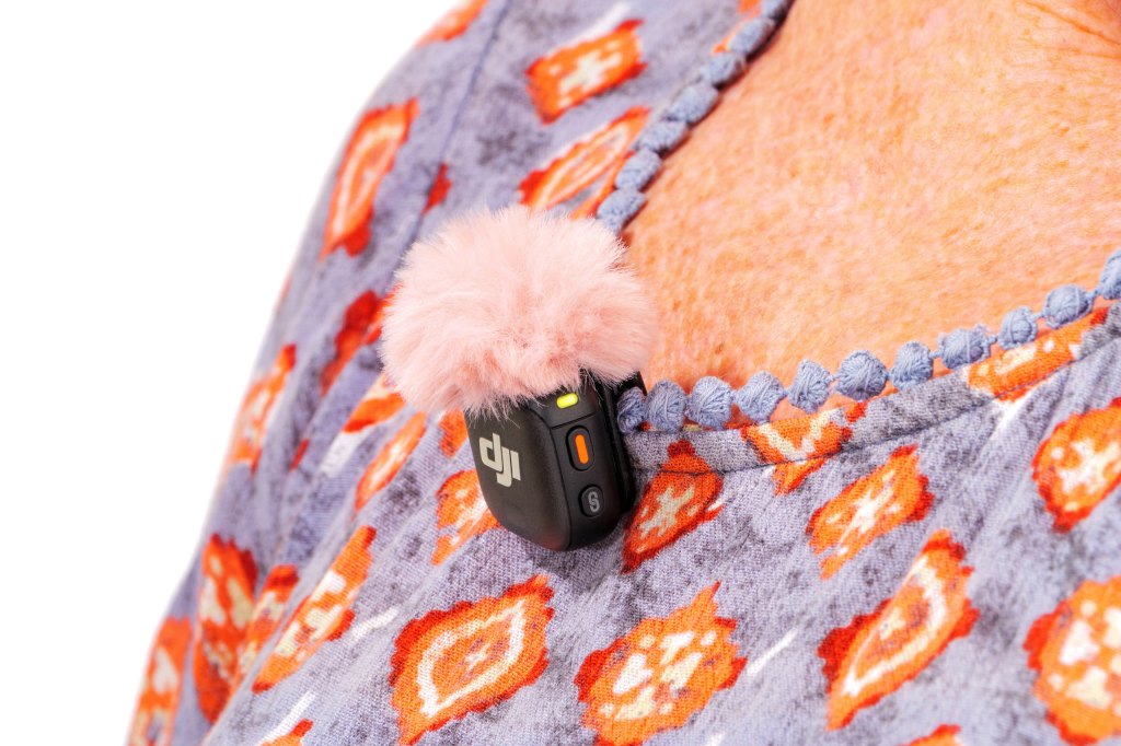DJI Mic 3 transmitter with windshield, clipped onto clothing