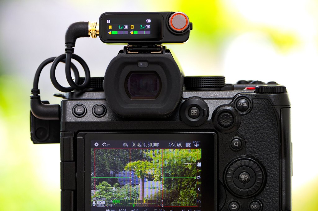 DJI Mic 3 in use, showing audio levels display