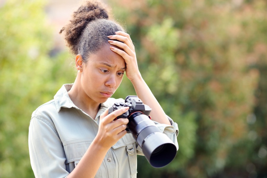 Worried photographer is unhappy with image on the camera. Pheelings Media, Getty Images