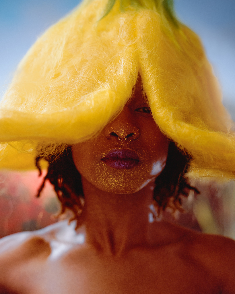 close-up portrait of woman wearing yellow flower headpiece