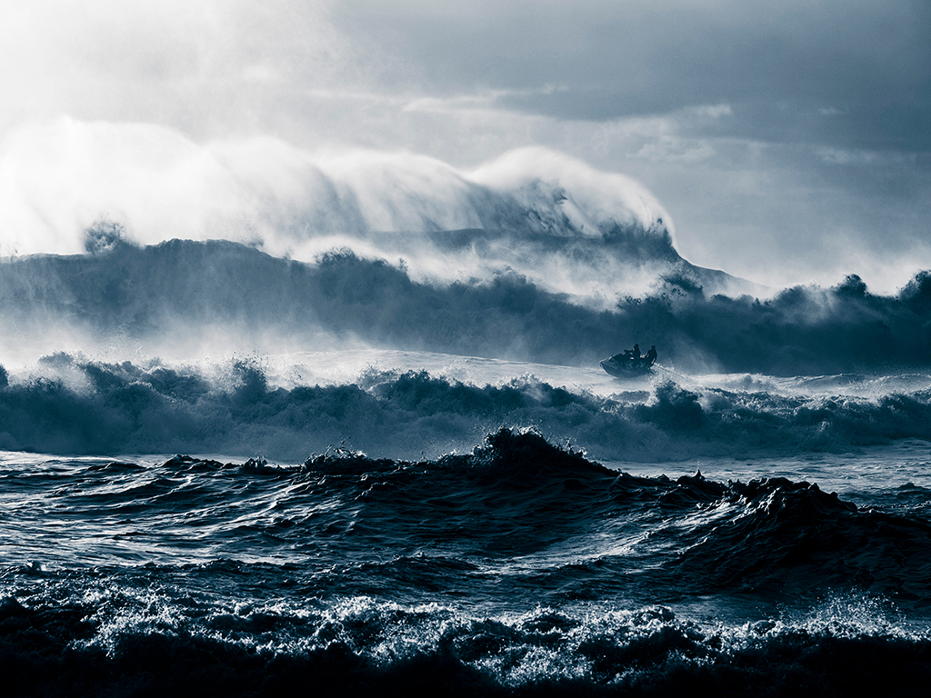 “A rough day at Nazaré,” says Thouard. “The wind was blowing from the north which makes the surf tricky. Not many surfers went out, but Justine Dupont and Eric Rebiere, who I was there to shoot, decided to give it a try. It was the end of the afternoon; the light was interesting from the beach instead as from the usual cliff view. It was hard to shoot anything because of the big sets and the saltwater in the air. But, eventually, this moment happened.”