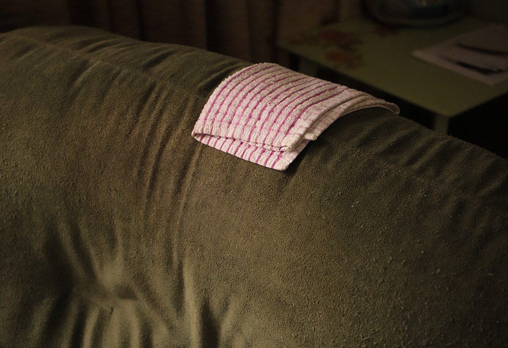 red and white check tea towel laying on the sofa