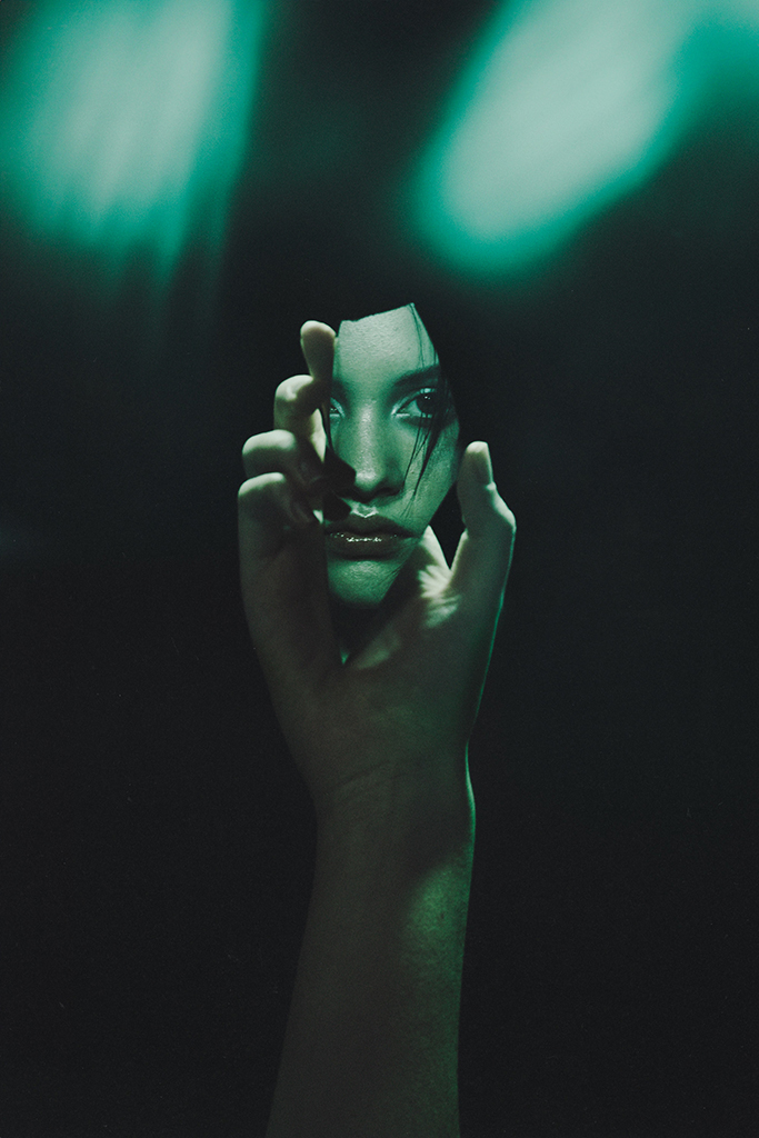 portrait of aubrie mitchell in a piece of mirror
