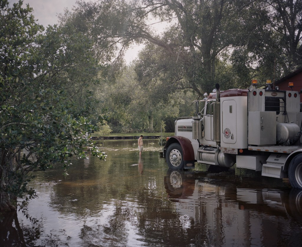 Series: Hurricane Season. Boy and Cherry Picker Truck 2012. Image Credit: Hannah Modigh