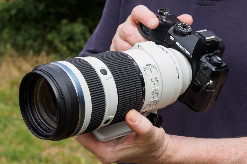 OM System 50-200mm F2.8 IS Pro in-hand on OM-1 Mark II.