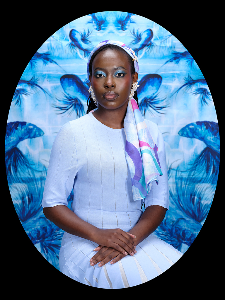 portrait of a woman wearing a scarf in her hair against a blue background