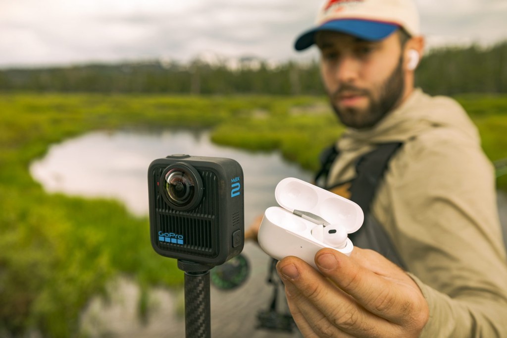 GoPro Max 2 being shown a pair of earphones. Image: GoPro