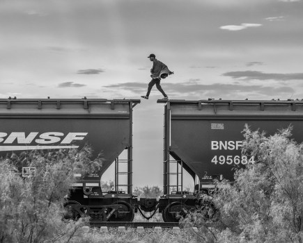 A migrant walks on top of a parked freight train known as “The Beast” on the outskirts of Piedras Negras, Mexico 2023. © Alejandro Cegarra/LOBA 2025