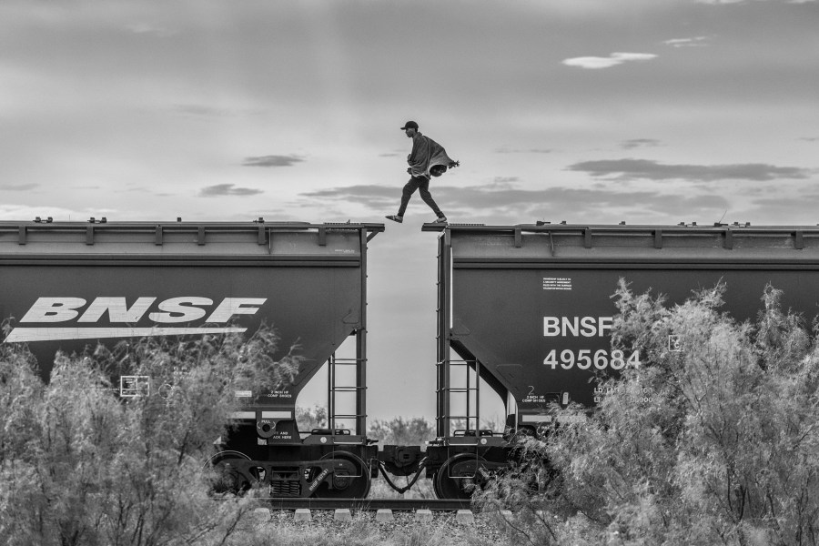 A migrant walks on top of a parked freight train known as “The Beast” on the outskirts of Piedras Negras, Mexico 2023. © Alejandro Cegarra/LOBA 2025