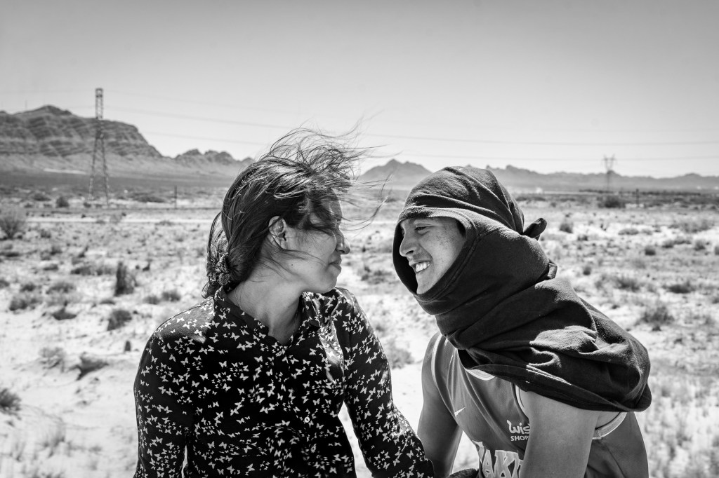Ruben Soto (right) a migrant from Venezuela, with Rosa Bello, a Honduran migrant, on top of the train known as “The Beast”. Samalayuca, Mexico 2023. From the series “The Two Walls” © Alejandro Cegarra/LOBA 2025