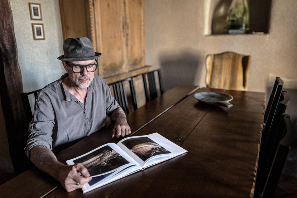 Pioneering photographer Charles Robert Mann with his book of Solargraphs.