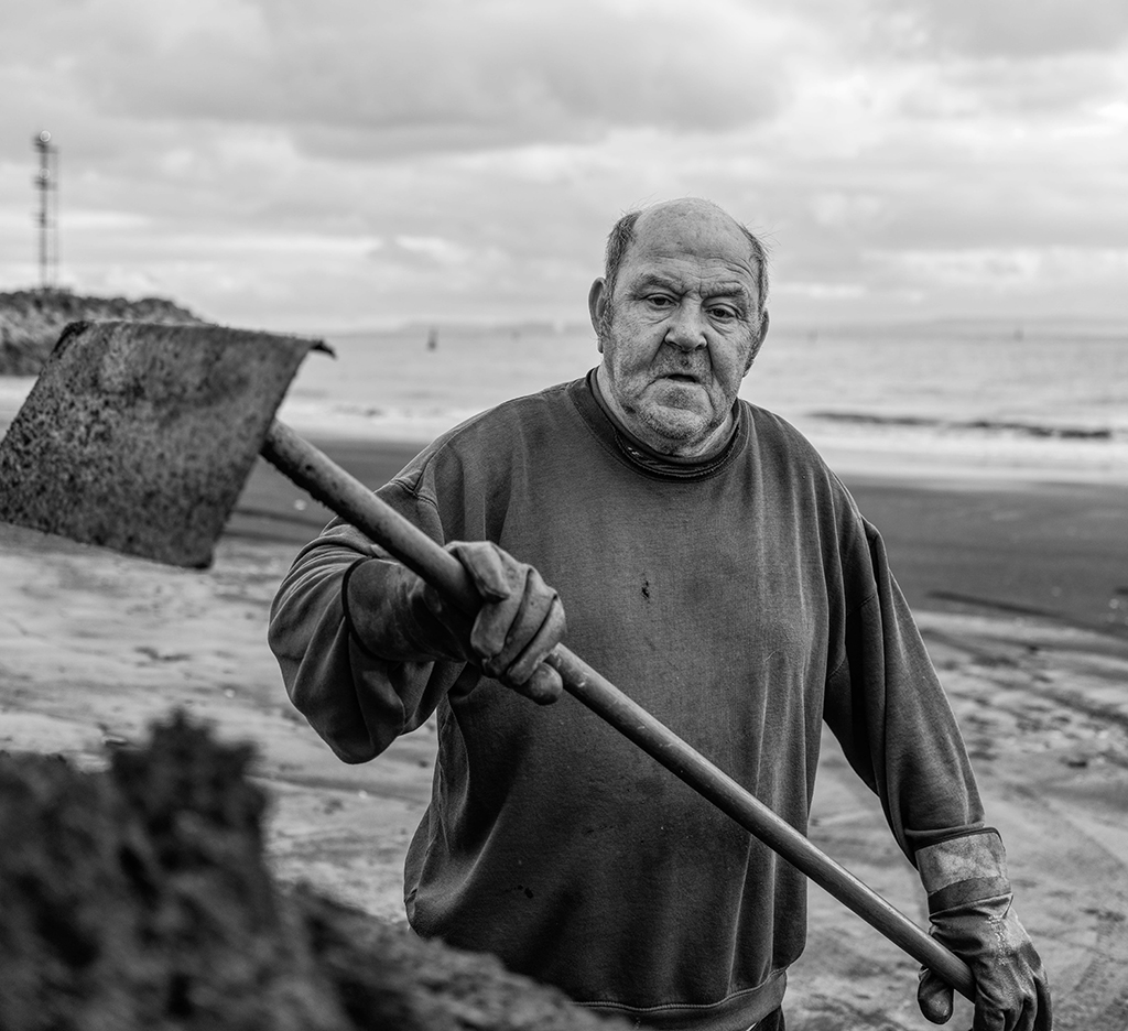 man holding large spade
