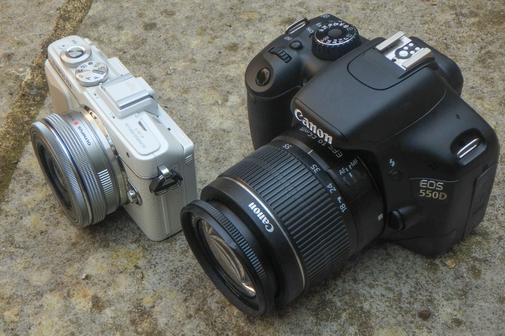 Canon EOS 550D DSLR next to Olympus PEN E-PL7. Image credit: Gavin Stoker