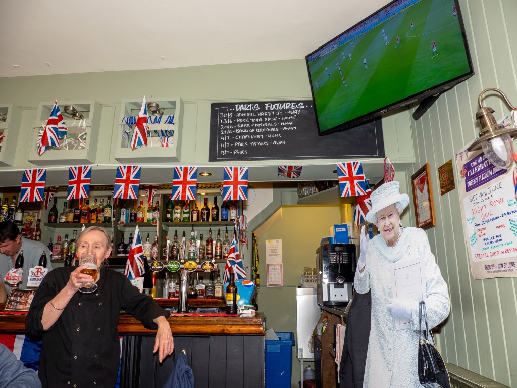 The Duke of Cornwall pub screening the Hungary versus England Nations League football match alongside a cut out of the Queen on June 04, 2022 in Weymouth, England. Image Credit: Peter Dench SINGLE USE ONLY