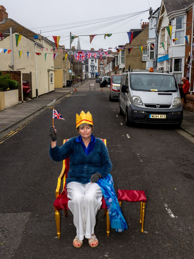 Queen of the street Lorraine Churchill on her throne at a party to celebrate the Queen's Platinum Jubilee on June 05, 2022 in Weymouth, England. Image Credit: Peter Dench SINGLE USE ONLY