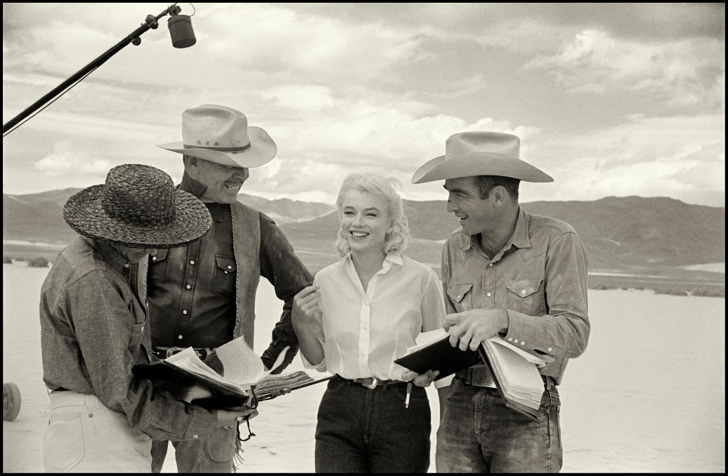 Marilyn Monroe in a light-hearted moment running through lines with Clark Gable and Montgomery Clift while filming The Misfits, Nevada, 1960 © The Estate of Eve Arnold