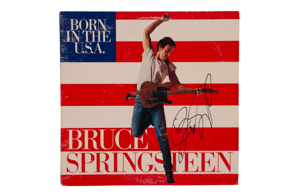 The cover of the Born in the U.S.A. single featured Bruce Springsteen jumping in the air with his guitar – this one was autographed by Springsteen. SINGLE USE ONLY. Copyright: Columbia Records/Annie-Leibovitz