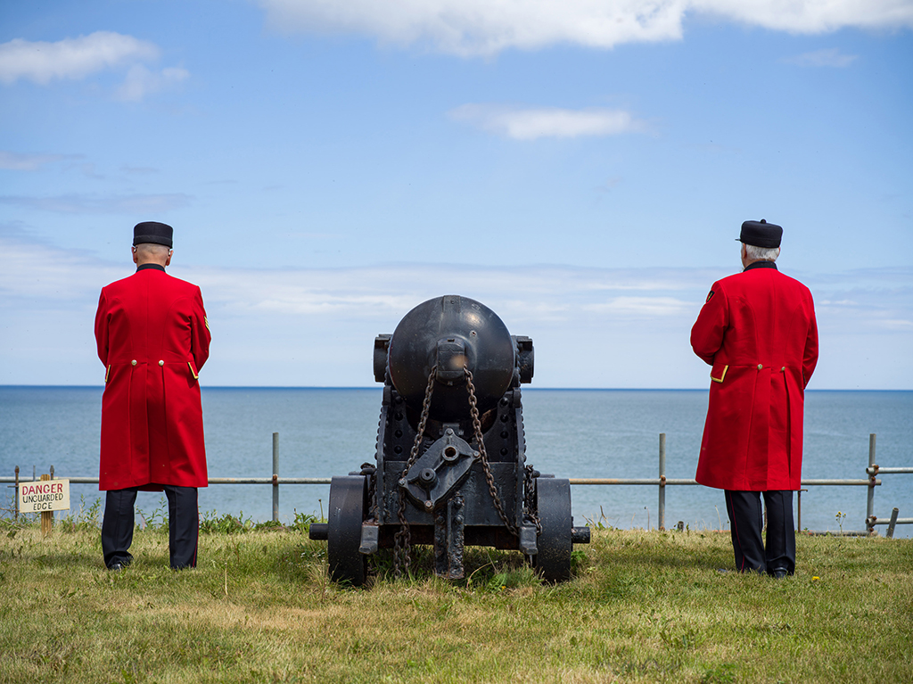 two men in red coat uniforms 