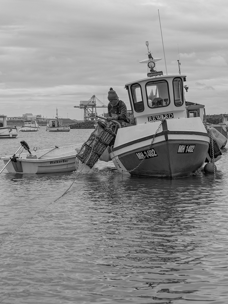 black and white image of a fishing boat