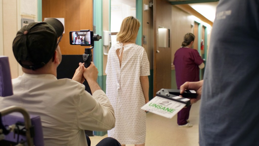 Behind the scenes photograph of Steven Soderbergh's 'Unsane', showing an iPhone being used to film star Claire Foy.