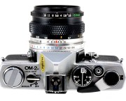 View from above showing the camera’s neatly-designed top plate and the usual Olympus style of shutter speed and aperture rings around the lens