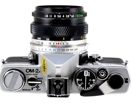 View from above showing the camera’s neatly-designed top plate and the usual Olympus style of shutter speed and aperture rings around the lens